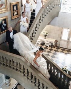 the bride and groom are walking down the stairs