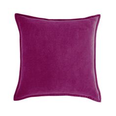 a purple pillow on a white wall