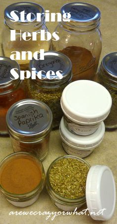 jars filled with spices sitting on top of a table next to each other and the words, storing herbs and spices