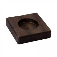 a square wooden object with a hole in the center on a white background, close up