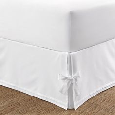 a white bed skirt with a bow on it