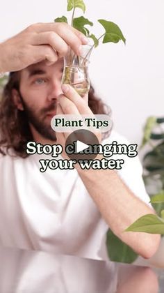 a man holding up a plant with the words plant tips stop caring your water on it