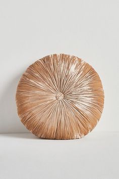 a round wooden object sitting on top of a white table