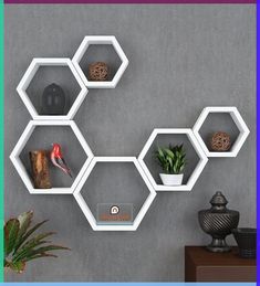 hexagonal shelves are arranged on the wall to display various items and decors