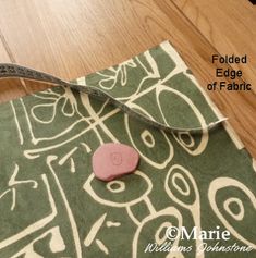 a piece of fabric with a pink heart on it