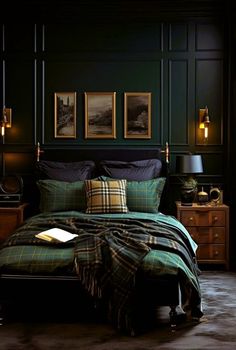 a bedroom with dark green walls and plaid bedspread, black comforter, gold framed pictures on the wall