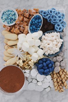 a platter filled with cookies, marshmallows, pretzels and other treats