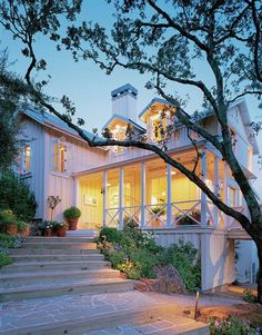 a large white house with stairs leading up to it