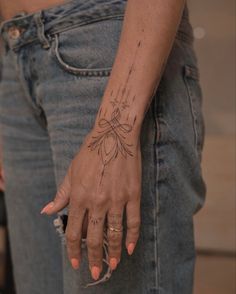 a woman's hand with a tattoo on it