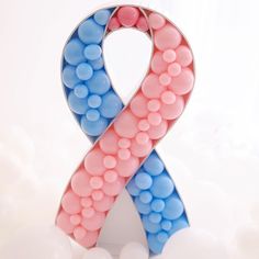 a pink and blue ribbon made out of balloons