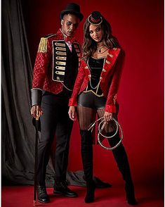 a man and woman dressed up in costume posing for a photo on a red background