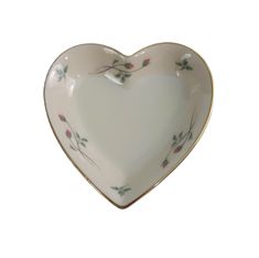 a heart shaped dish with flowers on it