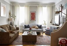 a living room with two couches, a coffee table and a rug on the floor