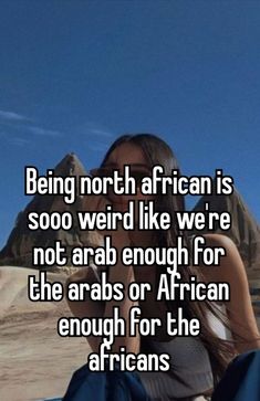 a woman sitting on top of a beach next to the ocean and texting being north african is sooo weird like we're not arab enough for