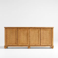 the sideboard is made out of wood and has wicker panels on one side