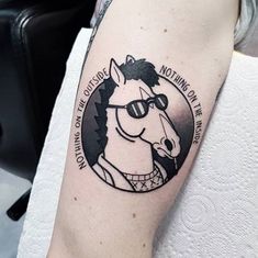 a man's arm with a horse tattoo on it and the words don't choose