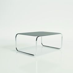 a glass table with metal legs on a white surface, viewed from the front view