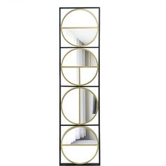 a tall black and gold shelf with three circular mirrors on it's sides, against a white background