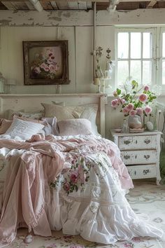 a bed with pink flowers on it in a bedroom next to a window and dresser