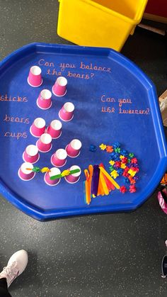 a child's play table with cupcakes on it and writing on the tray