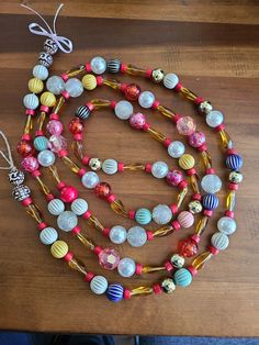 a multicolored beaded necklace on a wooden table