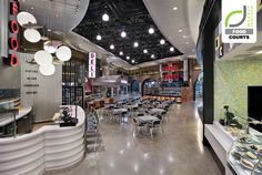 the inside of a restaurant with tables, chairs and food on display in front of them