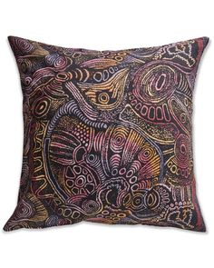 an intricately designed pillow on a white background with black and pink accents, including paisley patterns