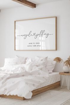 a bedroom with white bedding and a framed sign above the bed that reads, my whole selfly