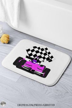 a bath mat with a pink race car on it and checkered flag in the background