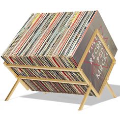 a stack of records sitting on top of a wooden stand