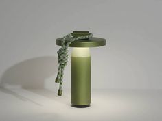 a green lamp with a rope attached to it