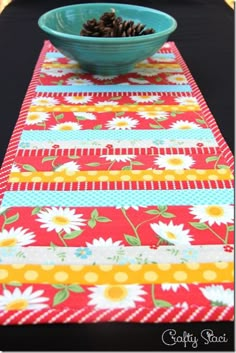 a blue bowl sitting on top of a table next to a red and yellow runner