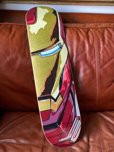 a close up of a skateboard on a leather couch in a room with brown furniture