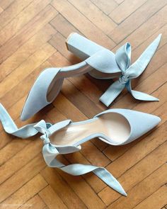 two pairs of blue shoes with bows on the heel and one pair of heels in the middle