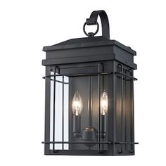 an outdoor light fixture with two lights on the front and back of it, in black