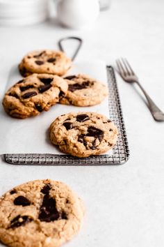 chocolate chip cookies sitting on top of a cooling rack