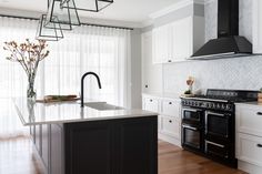 a kitchen with an oven, stove and counter top in the middle of the room