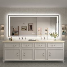 a bathroom vanity with two sinks and a large lighted mirror over the sink area in front of it