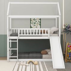 a white bunk bed with a slide next to it