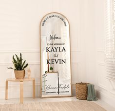 there is a mirror in the room with a sign on it that says welcome to the wedding of kaylia and kevin