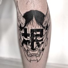 a black and white photo of a man's leg with tattoos on it