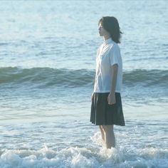 a woman standing in the ocean water