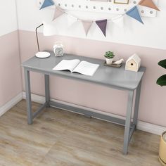 a wooden table with a book on it next to a potted plant