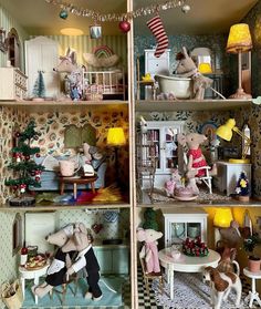 a doll house with many different rooms and animals on the shelves in front of it