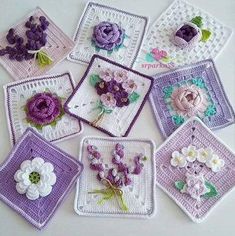 nine crocheted square coasters with flowers on them, all in purple and white