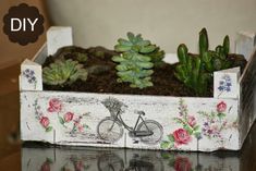 a planter with succulents and flowers in it is displayed on a table