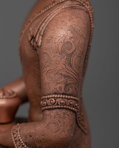 the back of a woman's body with intricate designs on her arm and leg