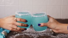 two women toasting with blue drinks in their hands