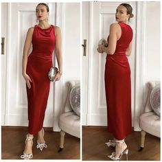 a woman in a red dress standing next to a white door and wearing high heels