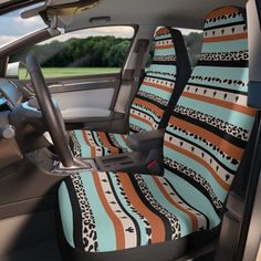 the interior of a car with an animal - print seat cover and matching steering wheel covers